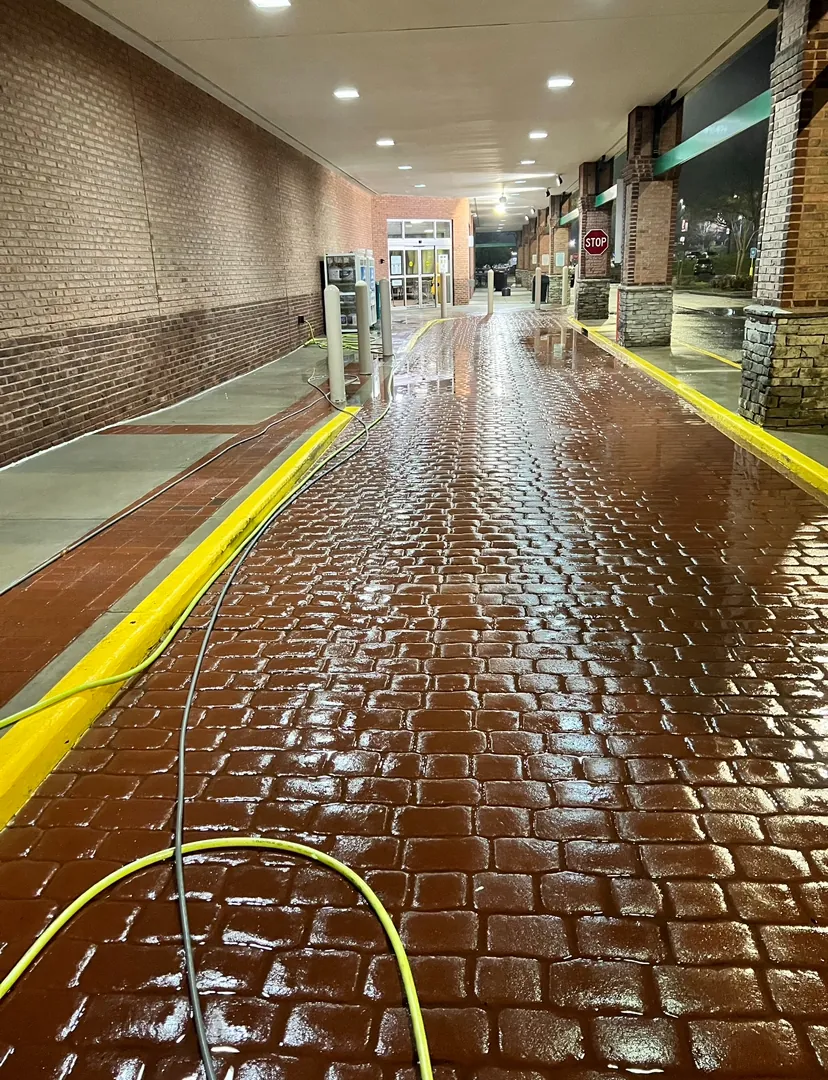 Wet stamped-concrete walkway in a shopping arcade